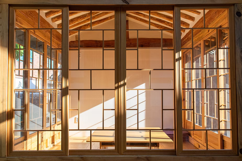 Sliding wooden doors in an indoor construction frame.