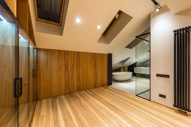 Room with wood flooring, recessed lighting, and wood-paneled accent wall