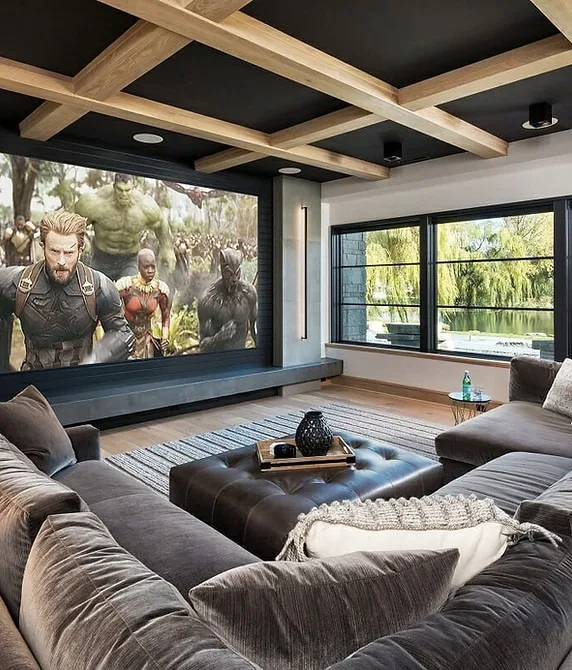 Cozy home theater with sectional seating, large screen, and wood beams.