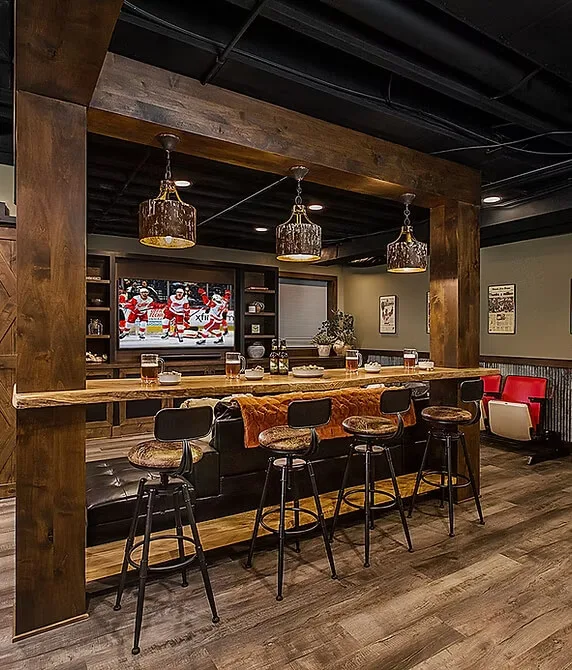 Rustic bar interior with wood accents and hanging lights.