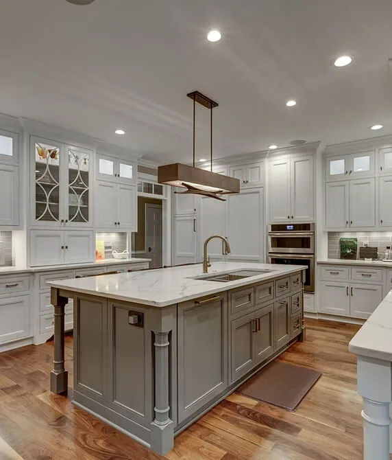 Bright kitchen with white cabinetry, center island, and pendant lighting.
