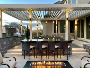 Luxurious outdoor lounge with white and peach cushions beside natural elements.
