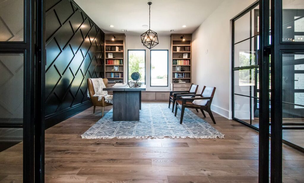 Elegant reading room with wood floors, dark wall paneling, and large window.