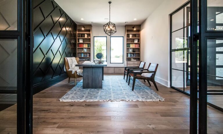 Elegant reading room with wood floors, dark wall paneling, and large window.