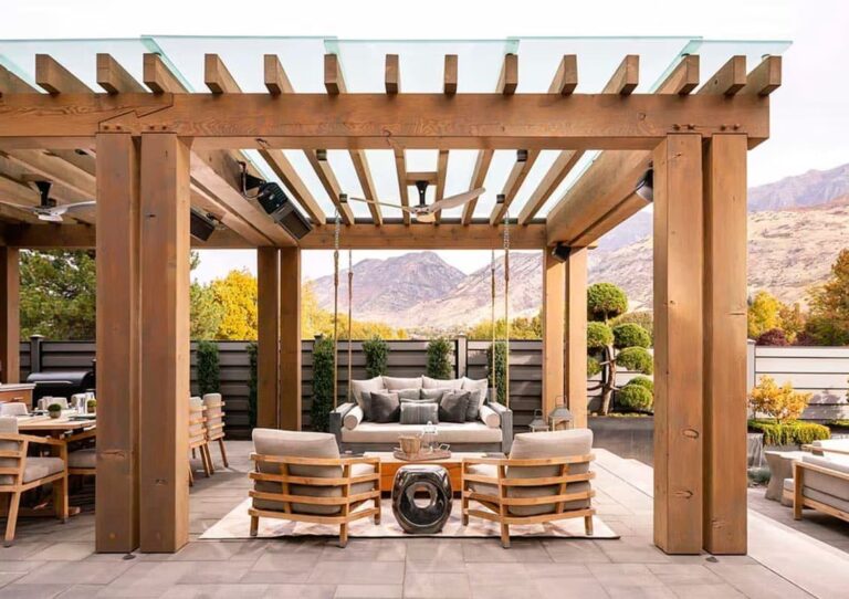Modern outdoor dining area with pergola and firepit centerpiece.