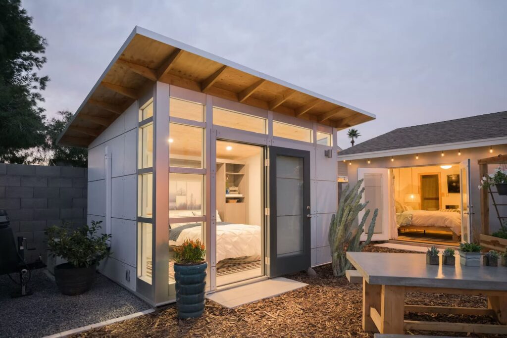 Small standalone structure or office with wood awning and porch.