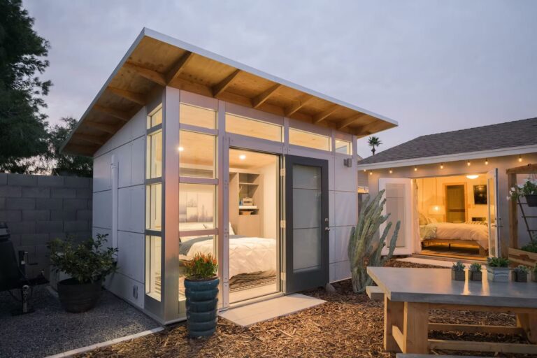 Small standalone structure or office with wood awning and porch.