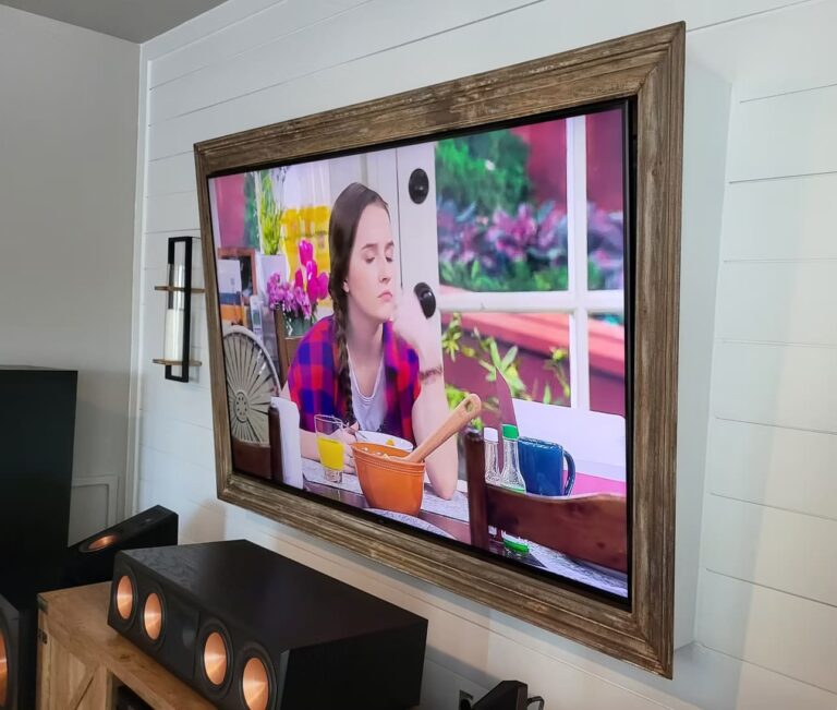 Wall-mounted TV displaying a colorful show in a modern living room.
