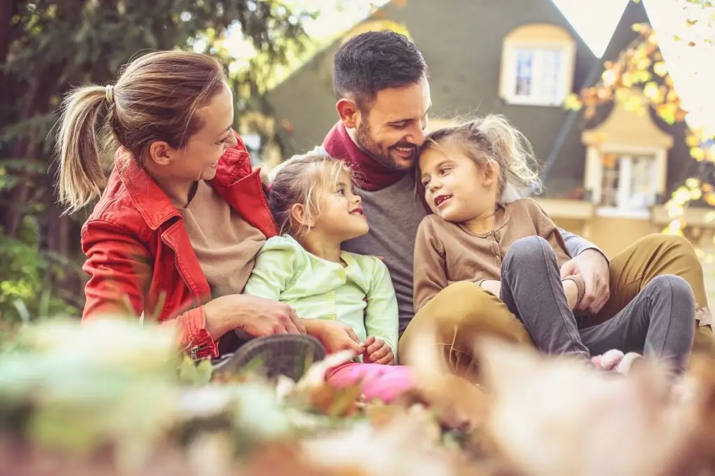 Happy family enjoying quality time together in a sunny outdoor setting.