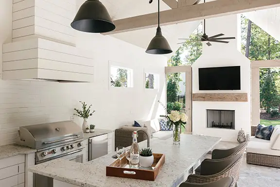 Modern farmhouse dining space with white walls and black light fixtures.