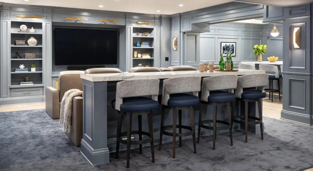 Home Bar: A stylish basement bar area with a white countertop, dark blue upholstered barstools, and integrated shelving.